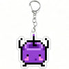 A purple pixel art charm of a Junimo character attached to a silver keychain ring.