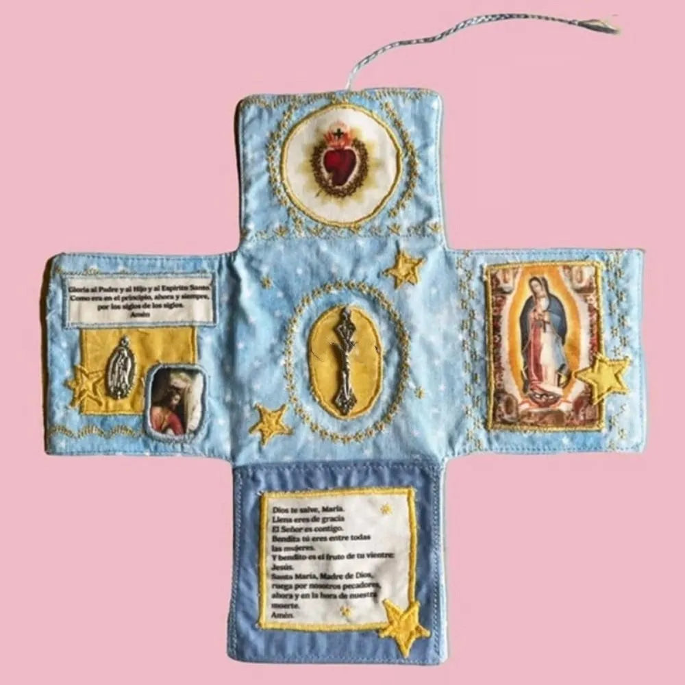 Handcrafted pocket devotional with a cross-shaped pouch featuring blue fabric and gold embroidery.
