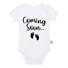 White baby bodysuit with black text that reads Coming Soon
