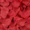 A close-up of deep red silk rose petals for weddings and events.