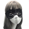 A black lace floral eye mask displayed on a mannequin head.