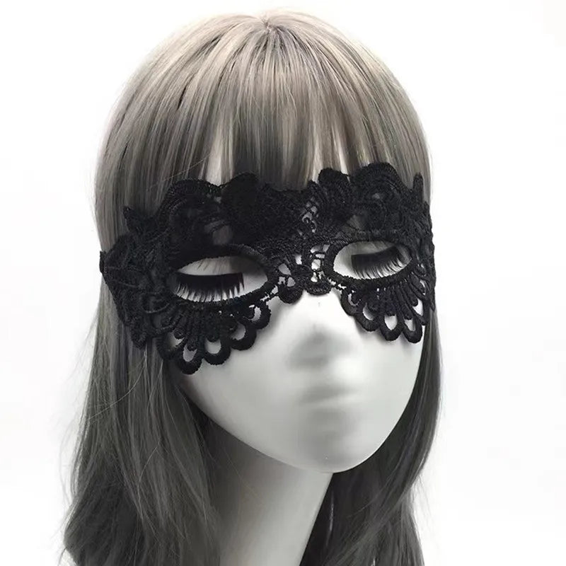A black lace floral eye mask displayed on a mannequin head.