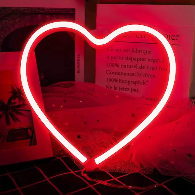 A bright red neon heart sign shaped like a butterfly for decoration or gifting