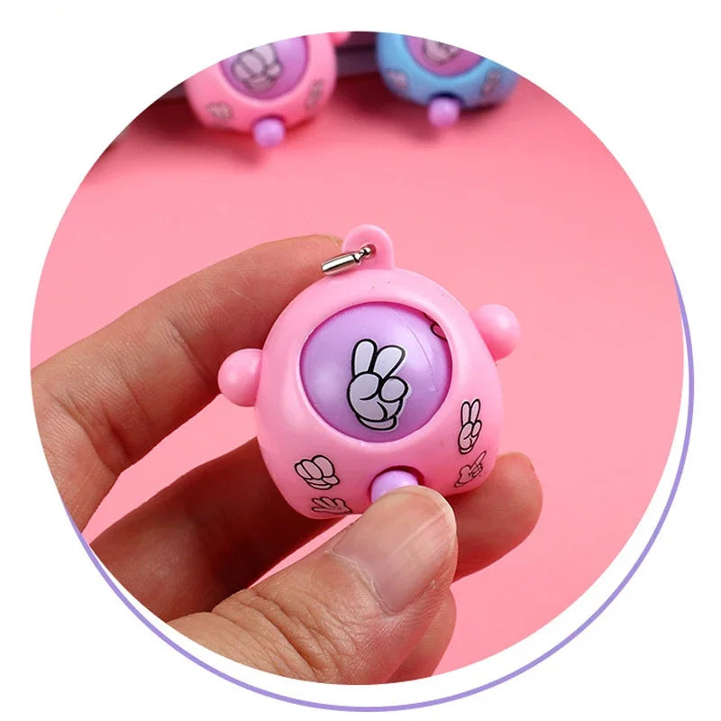A hand holds a pink guessing game egg with a paw print design, surrounded by other similar eggs.