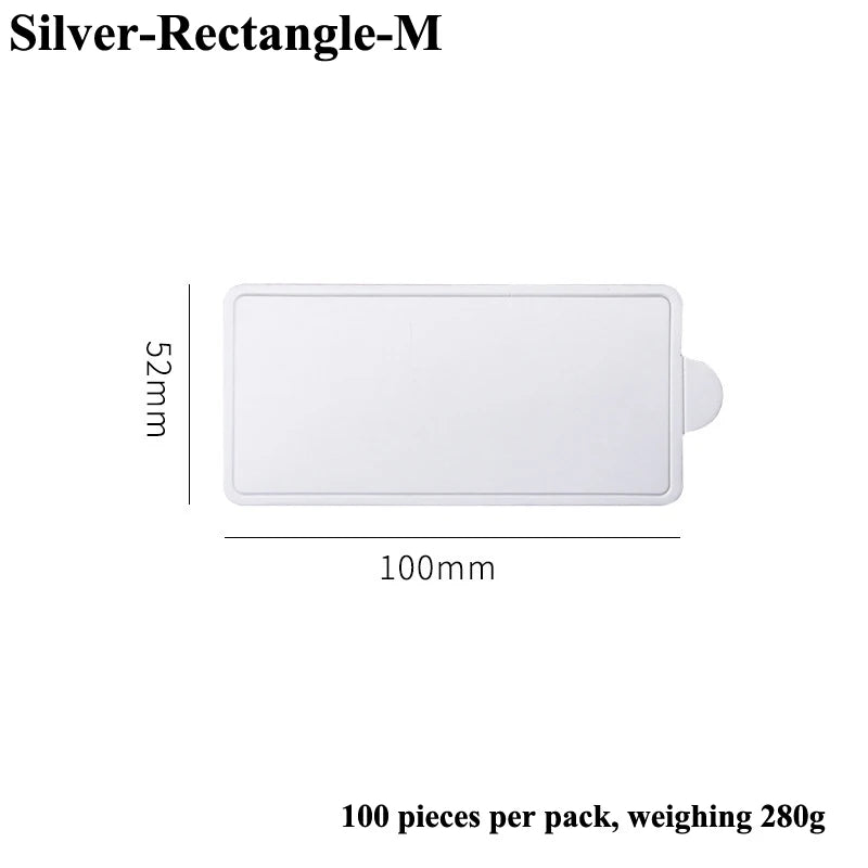 A white rectangular silver dessert cake board, 52mm by 100mm, sold in a pack of 100 pieces.