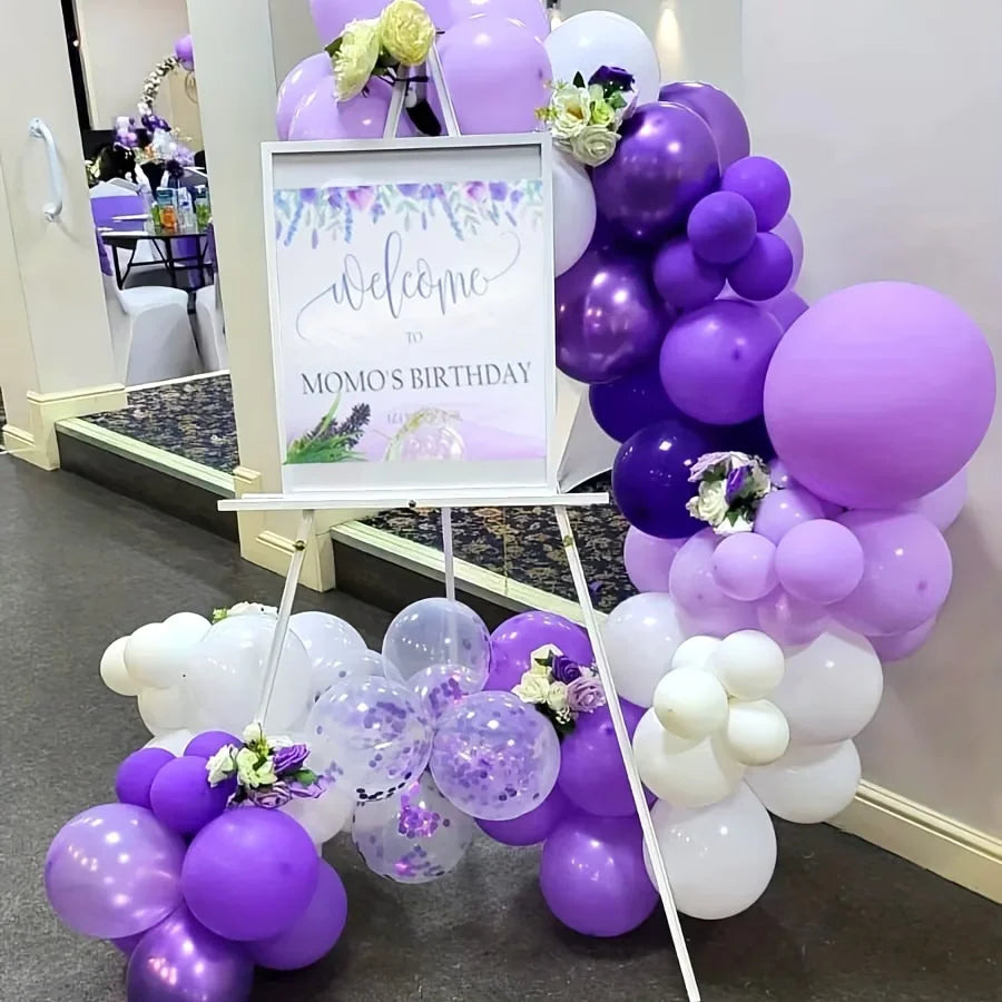 A balloon garland arch kit featuring purple and white balloons arranged in a vertical display.