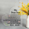A clear heart-shaped acrylic keepsake plaque engraved with the message My Dear Son I love you now and forever love mom