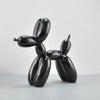 A glossy black resin sculpture shaped like a stylized dog or animal.