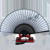 A vintage silk folding fan with black and white striped patterns is displayed on a wooden stand.