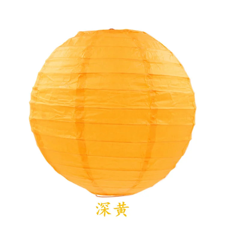 An orange round paper lantern with vertical folds.