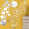 Yellow wall decorated with various size and shape acrylic mirror stickers