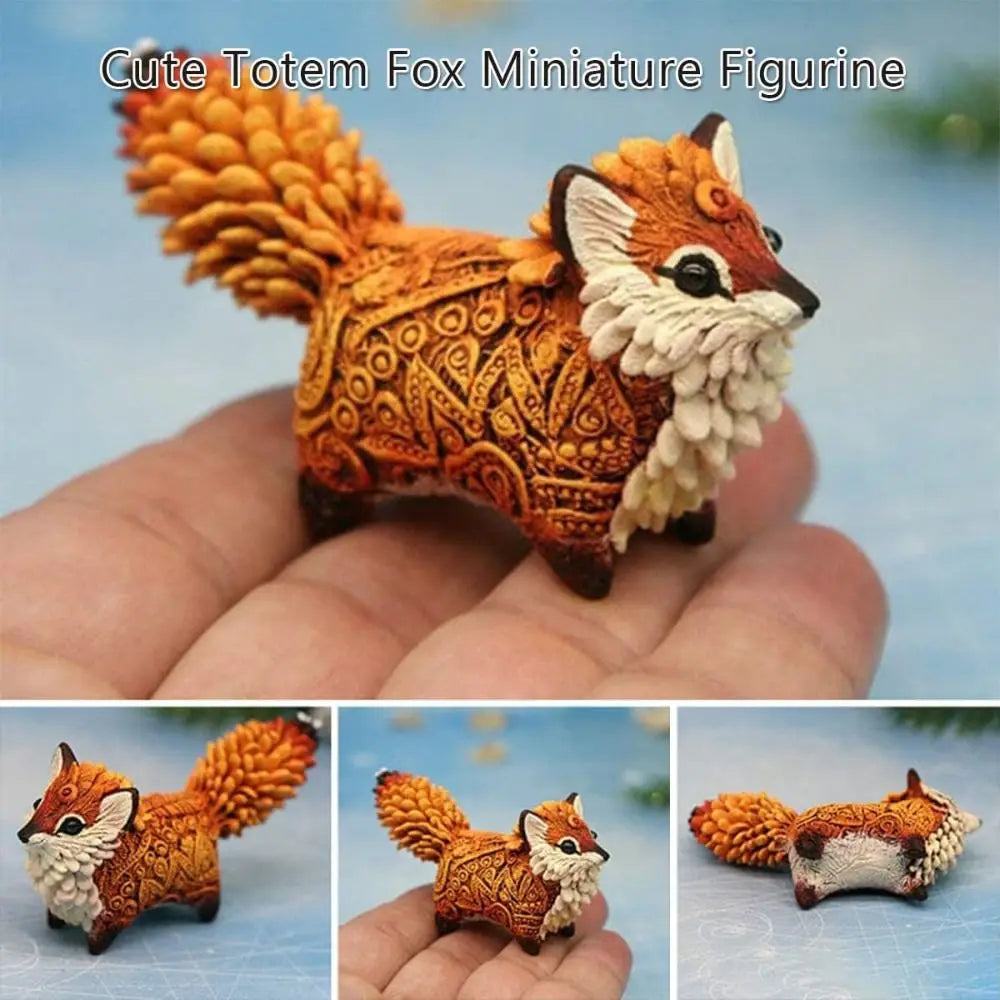 A hand-painted resin fox miniature figurine with an orange and white coat displayed in a person's palm.