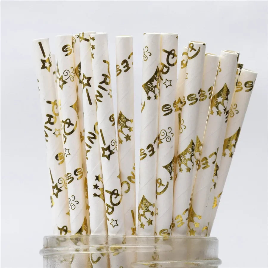 A bundle of white drinking straws decorated with gold stars and patterns
