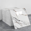 A stack of white marble tile stickers featuring natural gray and brown veining on a gray background.