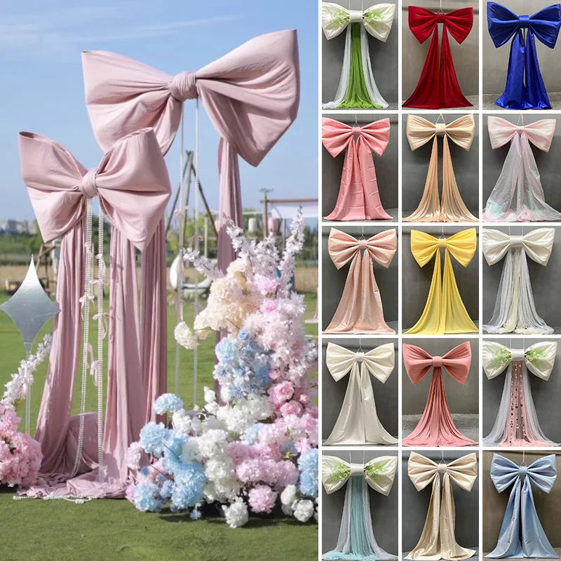 A collection of giant satin bows with long tulle drapes in various colors and styles for event decor.