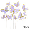 A collection of 50 paper butterfly cake toppers in shades of lavender and purple.