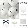 A set of 39 white latex balloons with black ribbon bows and glue dots for decoration