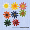 A set of nine metal flower wall decorations in various colors including yellow, orange, pink, and blue.