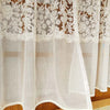 Beige sheer curtain featuring delicate floral embroidery and lace trim.