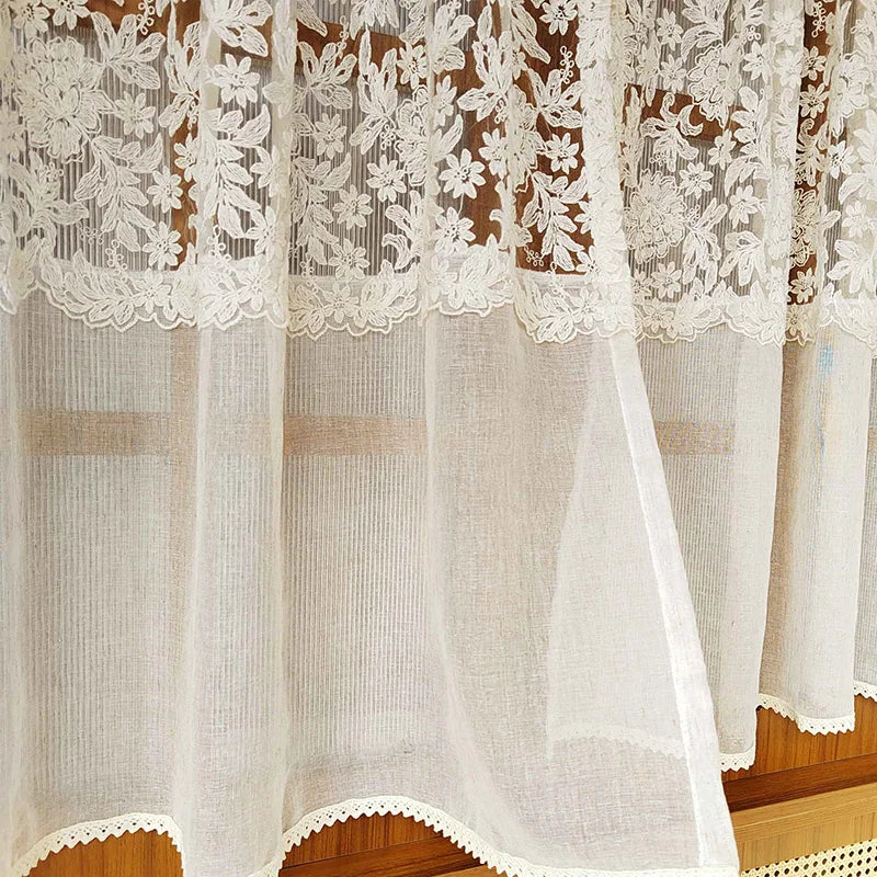 Beige sheer curtain featuring delicate floral embroidery and lace trim.