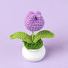Hand woven crochet purple flower potted in a white ceramic pot