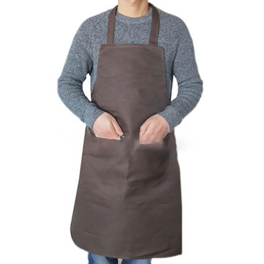 A person wearing a brown waterproof kitchen apron over a gray sweater.