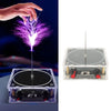 A hand is generating a purple electrical spark from an arc plasma music coil device.