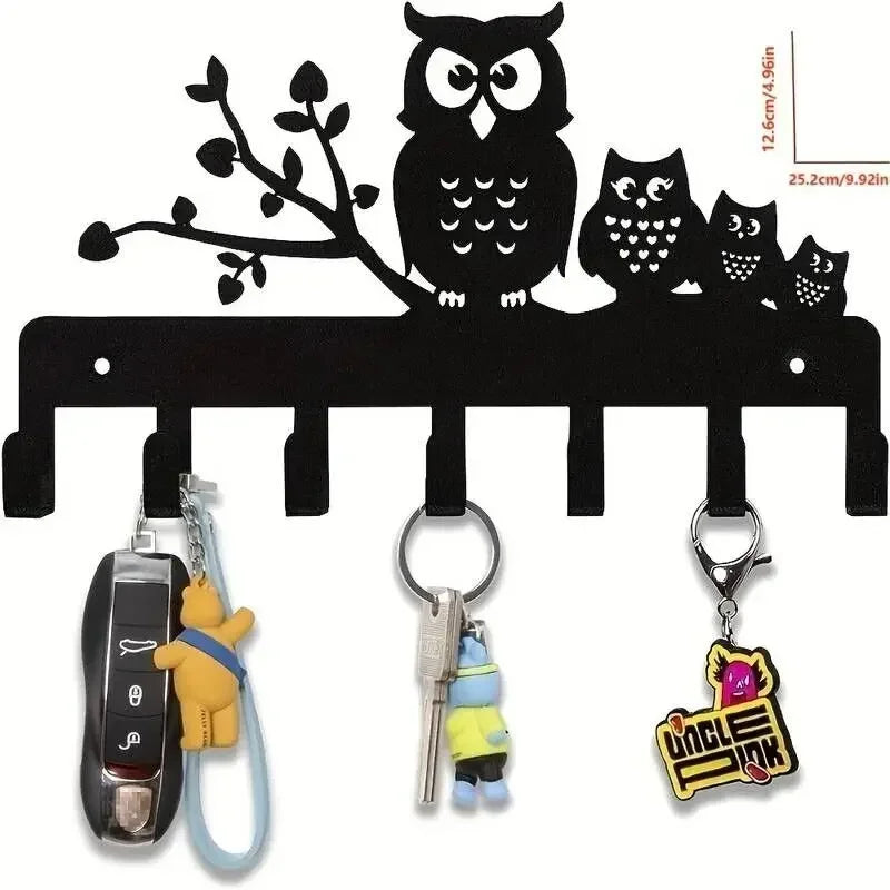 Black silhouette decorative metal key hooks featuring an owl and cat design for wall organization