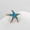 A starfish-shaped brooch pin set featuring blue and silver rhinestones.