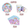 A set of unicorn themed birthday party supplies including a unicorn plate, cup, and paper decorations.