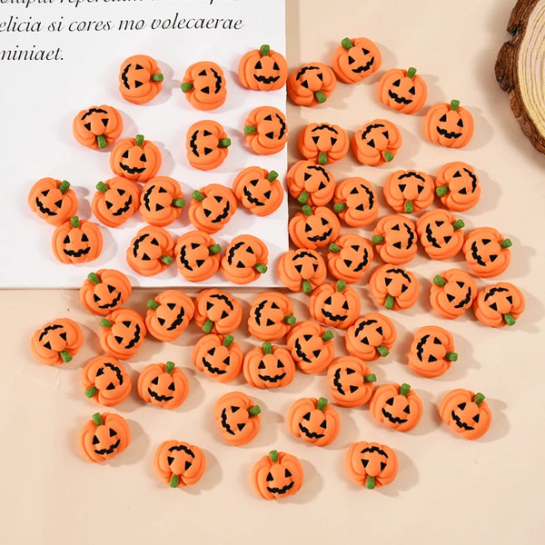 A collection of 20 orange resin pumpkin charms arranged in a diagonal pattern on a light background.