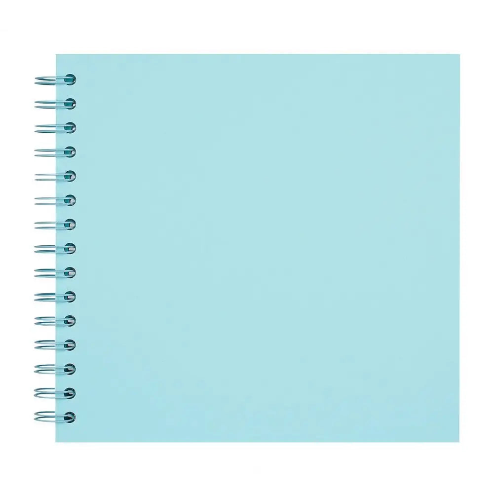 A blank, light blue spiral-bound notebook or scrapbook album.