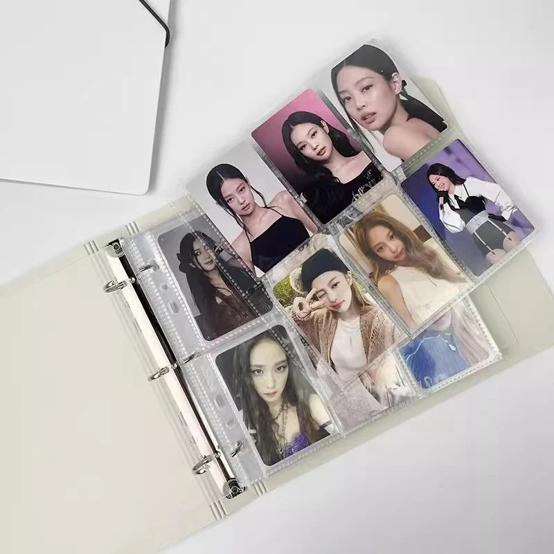 A photo card binder displaying several K-Pop idol photos in a transparent sleeve.