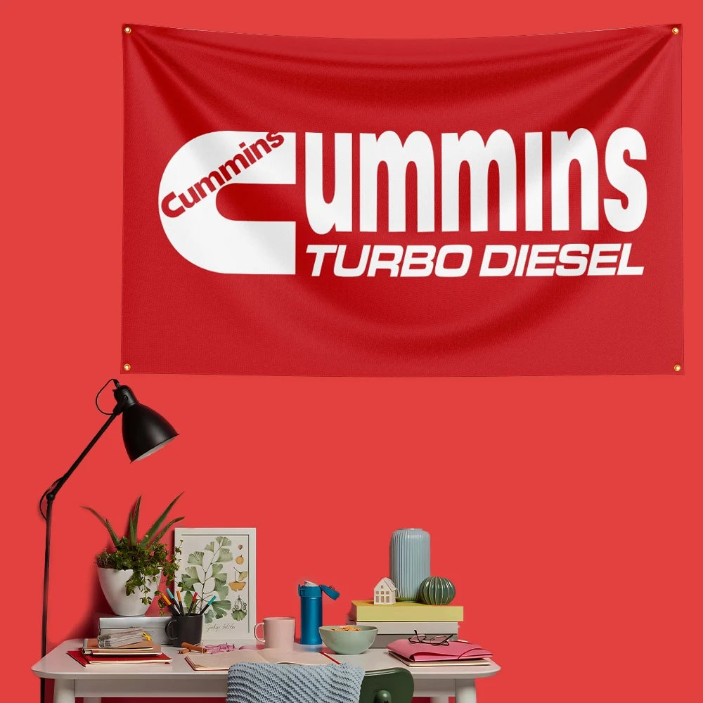 A red fabric banner featuring the Cummins Turbo Diesel logo on a red background.