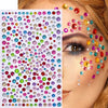 Close-up of a woman applying glitter gem stick-on facial tattoos to her eye and cheekbone.