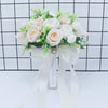 Elegant white silk rose bridal bouquet with green filler flowers tied with a sheer white ribbon