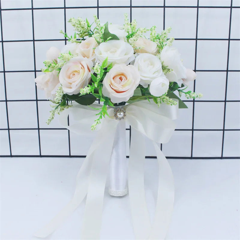 Elegant white silk rose bridal bouquet with green filler flowers tied with a sheer white ribbon