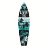 A black and teal tiki bar wooden wall decor sign shaped like a surfboard featuring palm trees and the text LIVIN THE DREAM.