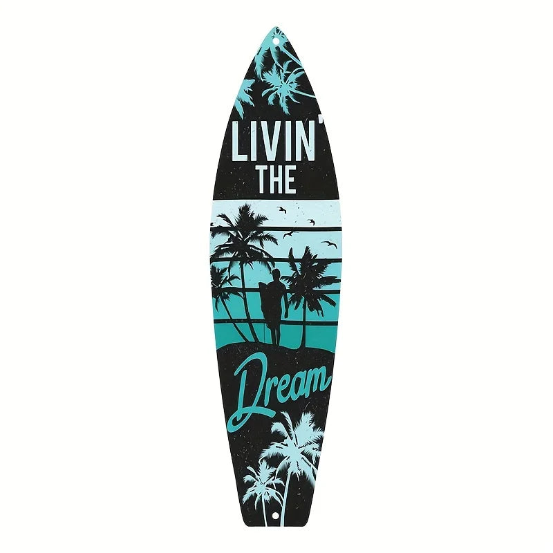 A black and teal tiki bar wooden wall decor sign shaped like a surfboard featuring palm trees and the text LIVIN THE DREAM.