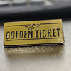 A gold enamel lapel pin ticket with the text WONKA GOLDEN TICKET.