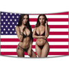 A woman wearing a black bra and panties stands in front of an American flag tapestry.