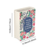 A ceramic book-shaped vase with a vintage floral design in pale green and pink tones.