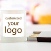 A white candle jar with text that reads customized your logo, next to a small box of wax pellets.
