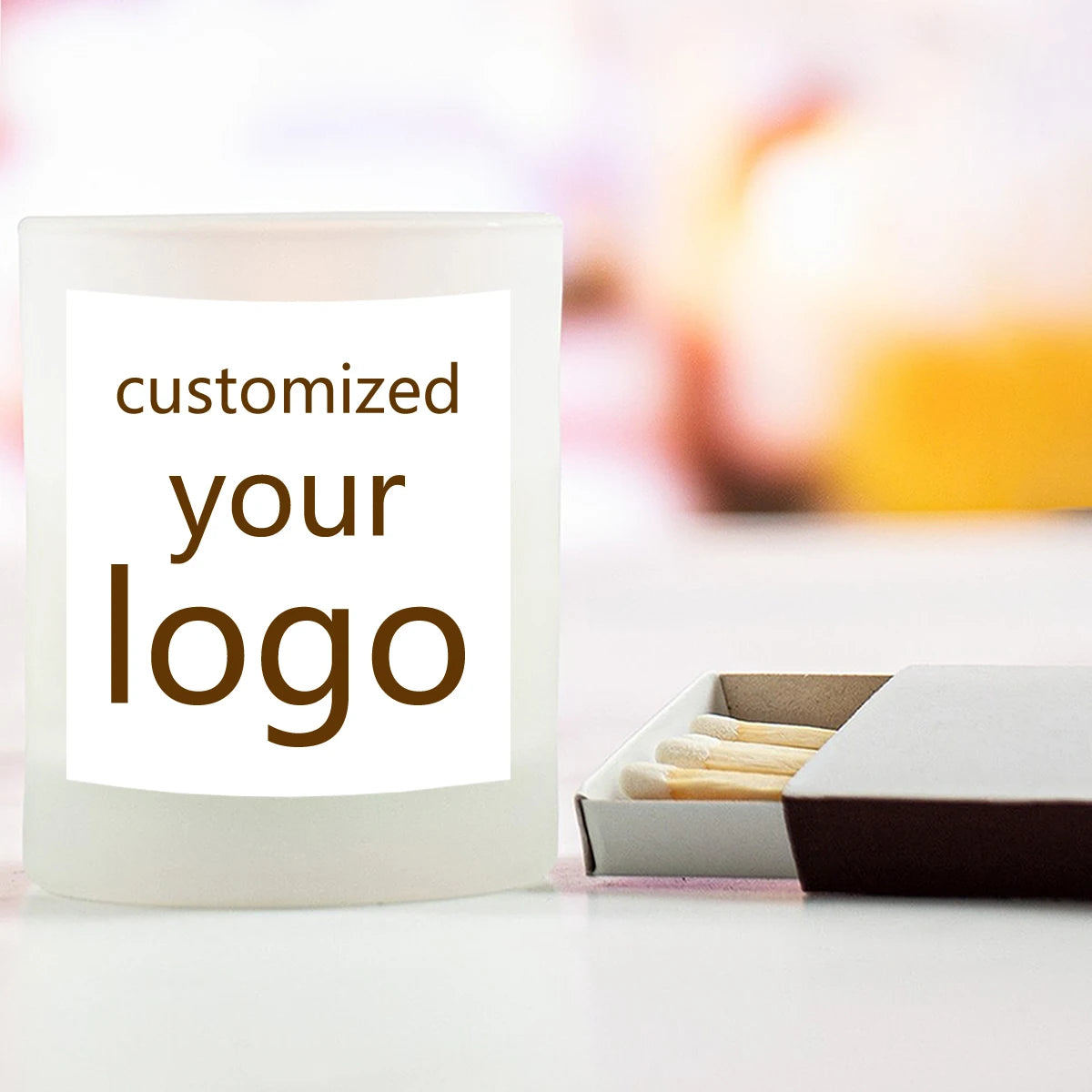 A white candle jar with text that reads customized your logo, next to a small box of wax pellets.