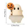 A white ghost phone decoration charm with an orange jack-o'-lantern face on the ear.