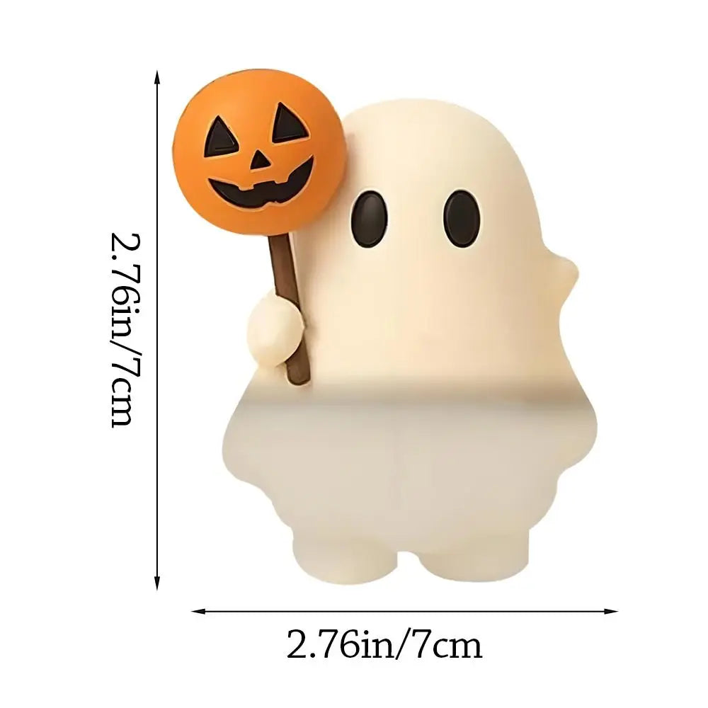 A white ghost phone decoration charm with an orange jack-o'-lantern face on the ear.