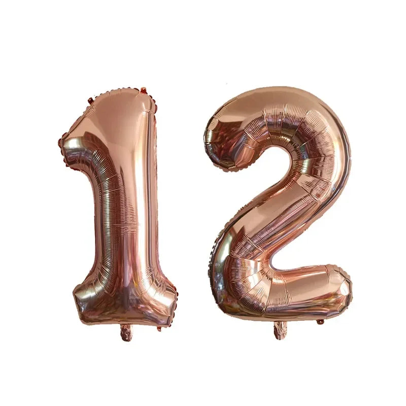 Two metallic rose gold foil number balloons shaped like 1 and 2