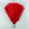 A vibrant red artificial pampas grass plume used for boho wedding and home decor.
