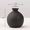 A matte black ceramic vase with a rounded body and narrow neck, shown against a white background.
