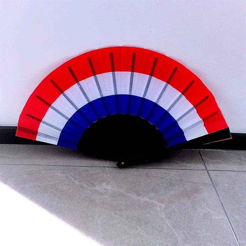 A handheld folding fan featuring the colors of the country flag, displaying red, white, and blue stripes.